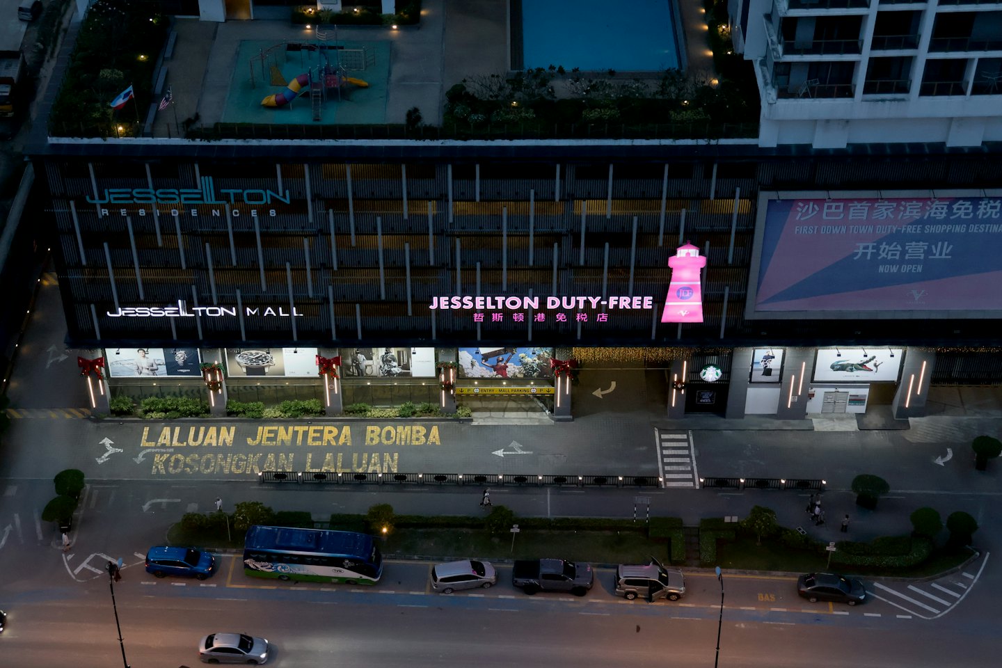Jesselton Mall and Residences building illuminated at night.